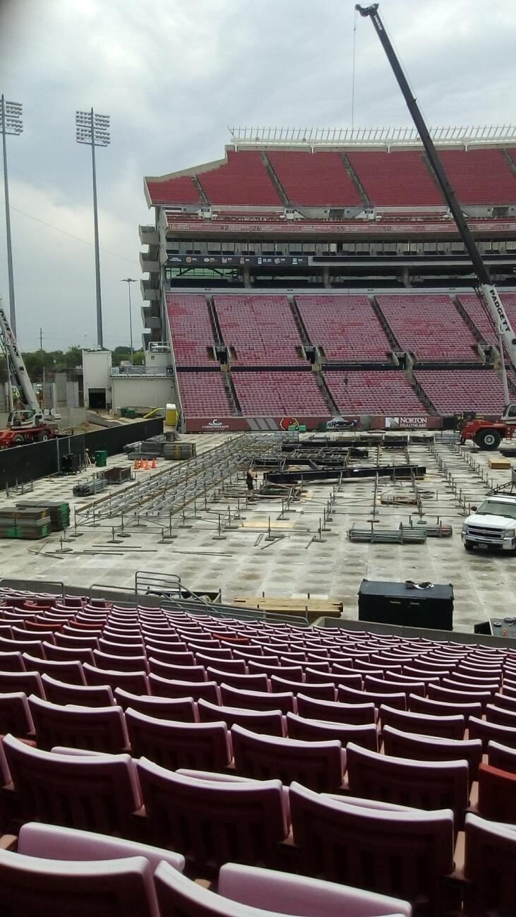 Festival stage and PA wings being built out on a stadium pitch