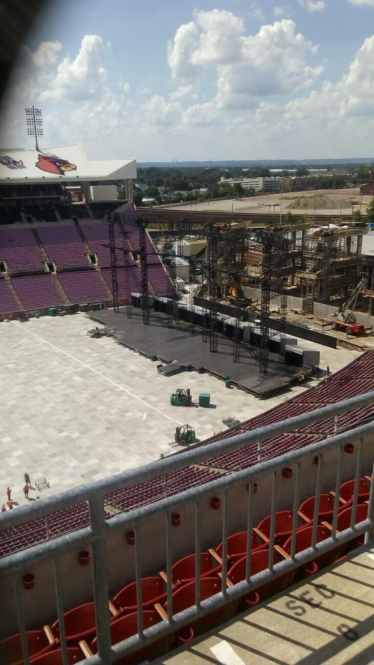 Open-air stadium stage under construction in daylight