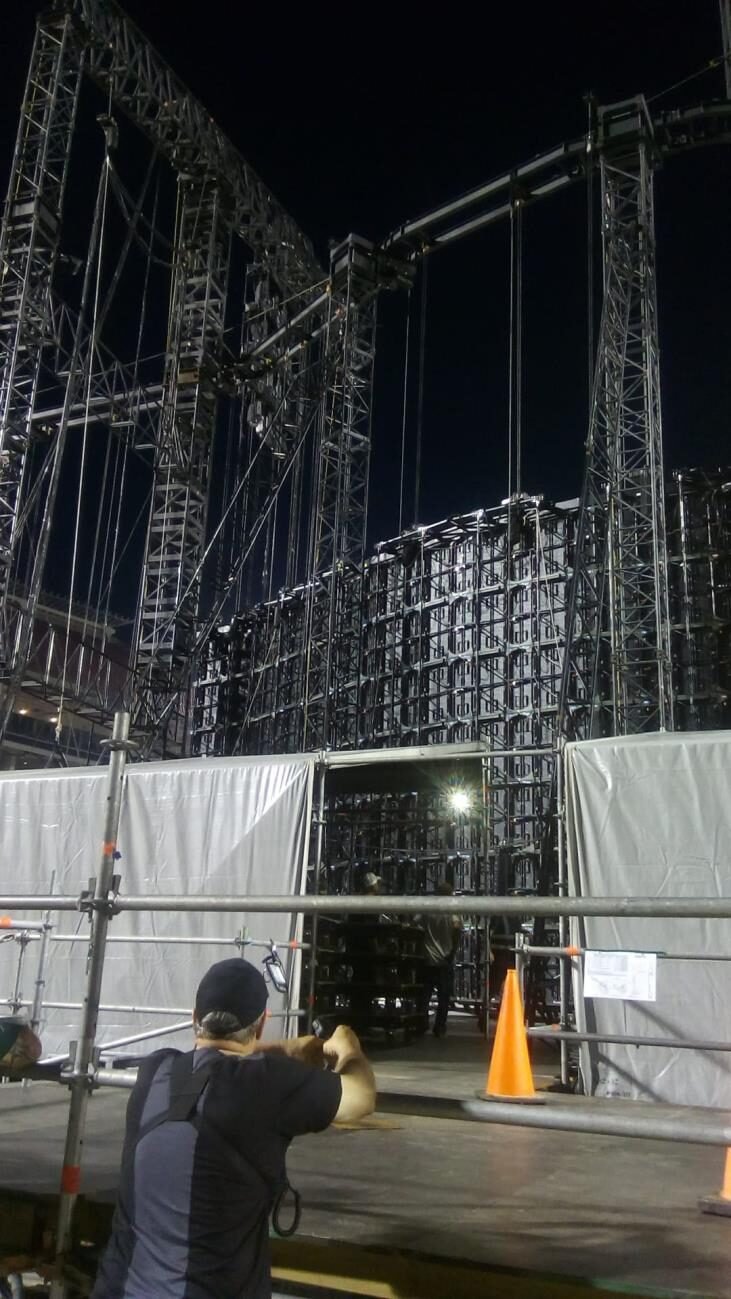 Ground-support truss towers built for an arena show, inspected at night